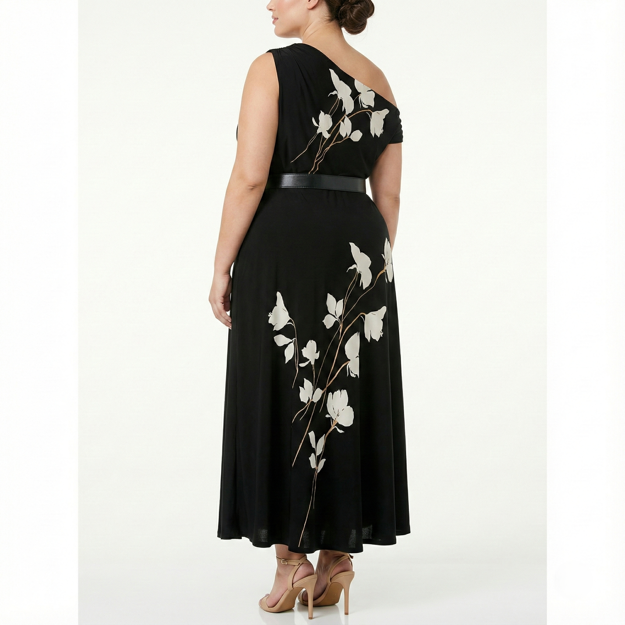 Three-quarter back view of plus-size black one-shoulder maxi dress with white floral print, belted waist, and flowy silhouette.