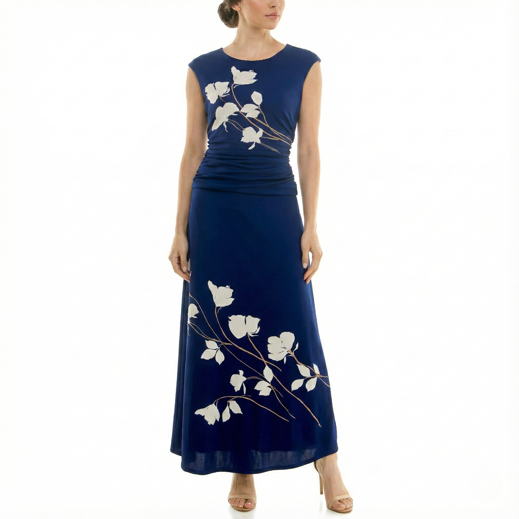 Front view of model wearing a navy sleeveless midi dress with ivory floral print, ruched waist, flowing skirt, and nude high-heel sandals.