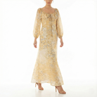 Front view of a women’s yellow floral maxi dress featuring a gathered scoop neckline, long sheer puff sleeves, and lightweight flowing fabric.