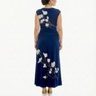 Back view of a women’s navy blue sleeveless maxi dress with ivory floral print, highlighting the straight column silhouette, smooth back, and floor-length skirt.