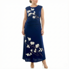 Front view of a women’s navy blue sleeveless maxi dress with ivory floral print, ruched waist detail, and ankle-length skirt, styled with nude heels.