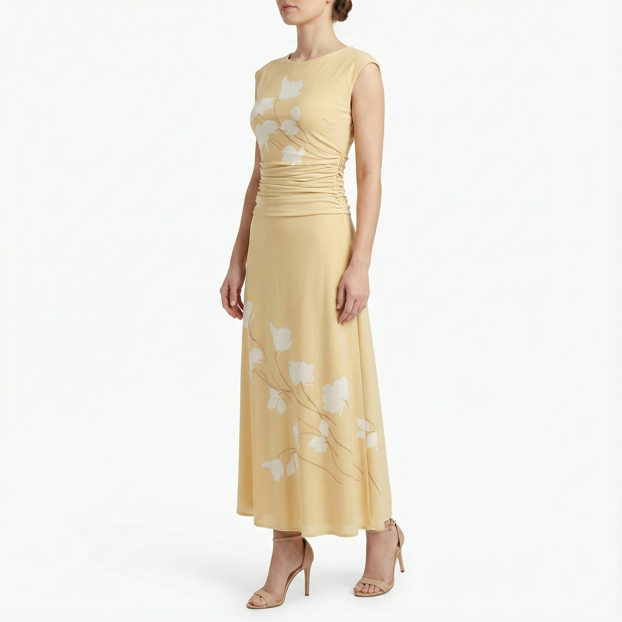 Side view of cornsilk yellow sleeveless midi dress featuring white floral pattern, fitted ruched bodice, flowing midi skirt, and nude high-heel sandals.