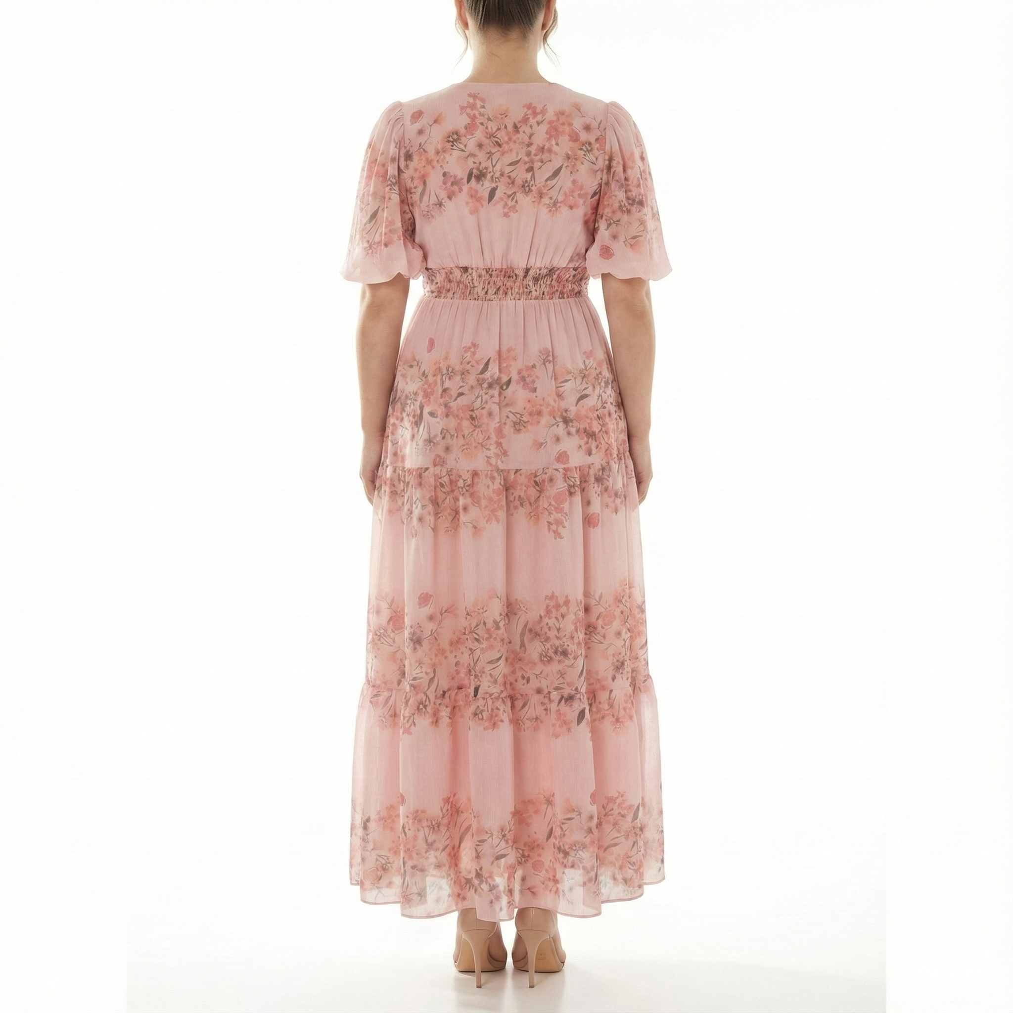 Full back view of blush pink floral chiffon maxi dress featuring short puff sleeves, smocked waistband, and tiered ankle-length skirt.