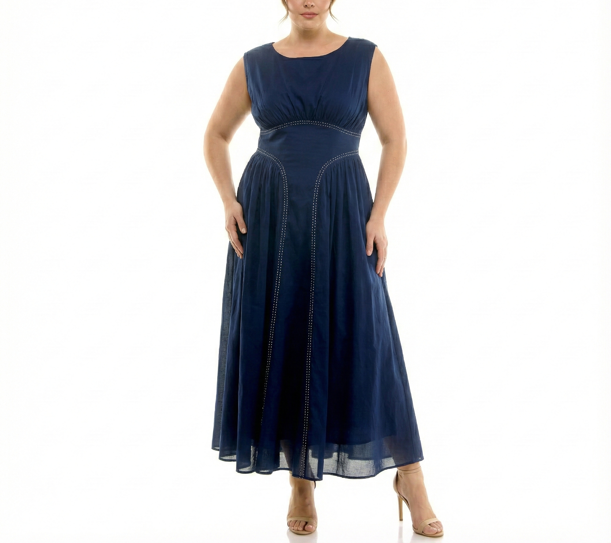 Plus-size navy blue sleeveless maxi dress with empire waist, flowing chiffon skirt, and decorative contrast stitching, front view on model.