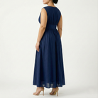 Plus-size navy blue sleeveless maxi dress with empire waist and long flowing chiffon skirt, back view showing gathered waist and full-length silhouette.