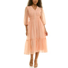 Front view of a peach sheer midi dress featuring a V-neck, decorative front buttons, cinched waist, flowy tiered skirt, and three-quarter puff sleeves.