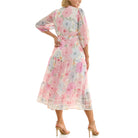 Back view of women’s pastel floral chiffon midi dress featuring tiered skirt and adjustable waist tie