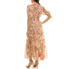 Back view of a floral chiffon maxi dress with smocked waistband, puff sleeves, and flowing tiered skirt.