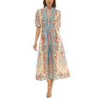 Floral midi dress with blue vertical panel, puff sleeves, and empire waist, front view.